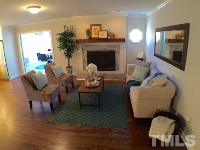 5016 Dantree Place Raleigh, NC 27609 - Photo 4 of 16 a living room with furniture and a fireplace