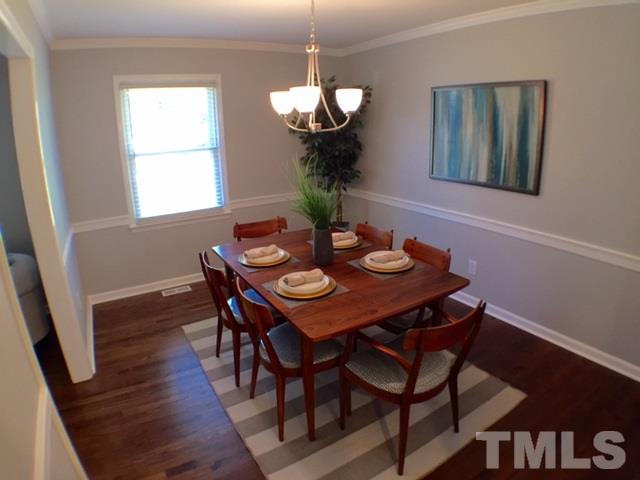 5016 Dantree Place Raleigh, NC 27609 - Photo 9 of 16 a view of a dining room with furniture wooden floor and chandelier