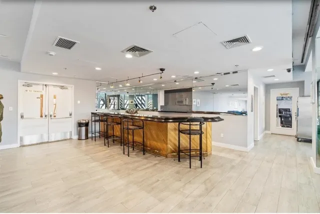 a kitchen with stainless steel appliances kitchen island granite top and refrigerator
