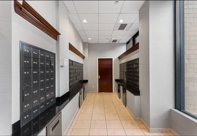 a hallway with a large mirror in a bedroom