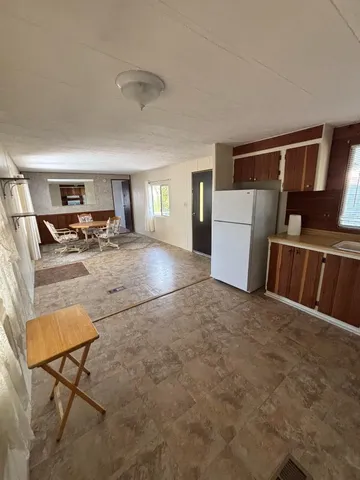 a view of a livingroom with furniture and a kitchen