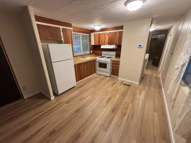 a kitchen with white cabinets and white appliances