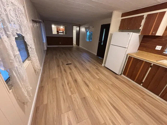 a view of an entryway with wooden floor