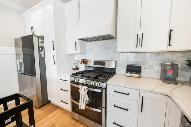 a kitchen with stainless steel appliances white cabinets and a stove