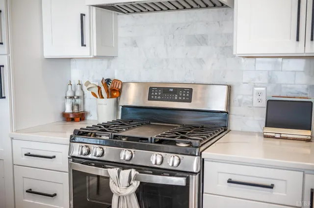 a stove top oven sitting inside of a kitchen