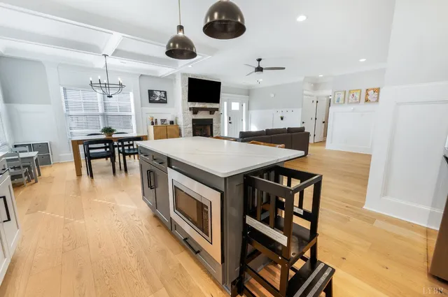a open kitchen with stainless steel appliances granite countertop a stove and a refrigerator