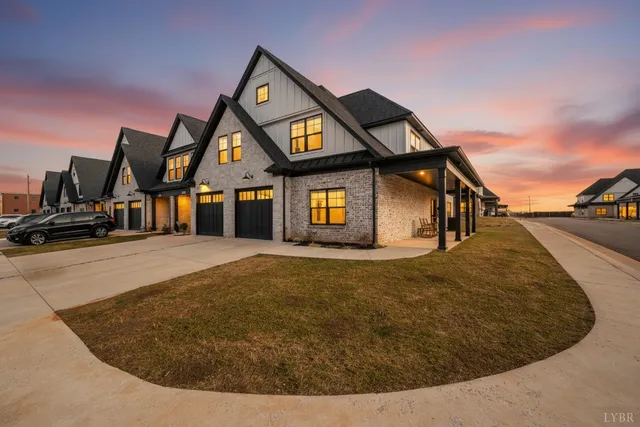 a front view of a house with swimming pool and porch