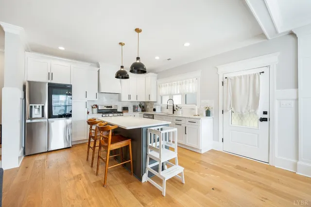 a kitchen with stainless steel appliances kitchen island granite countertop a sink and cabinets