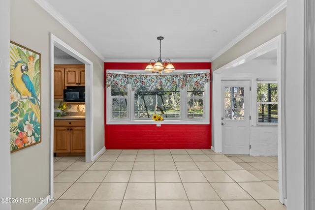 a spacious bedroom with a bed and a chandelier