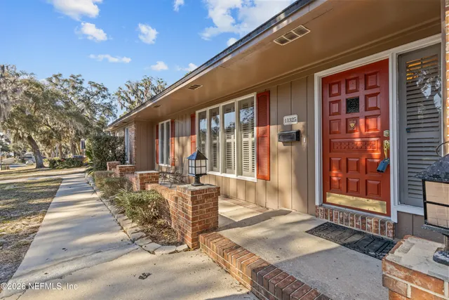a view of a house with backyard porch and sitting area