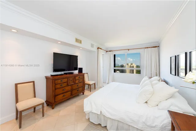 a bedroom with furniture and flat screen tv