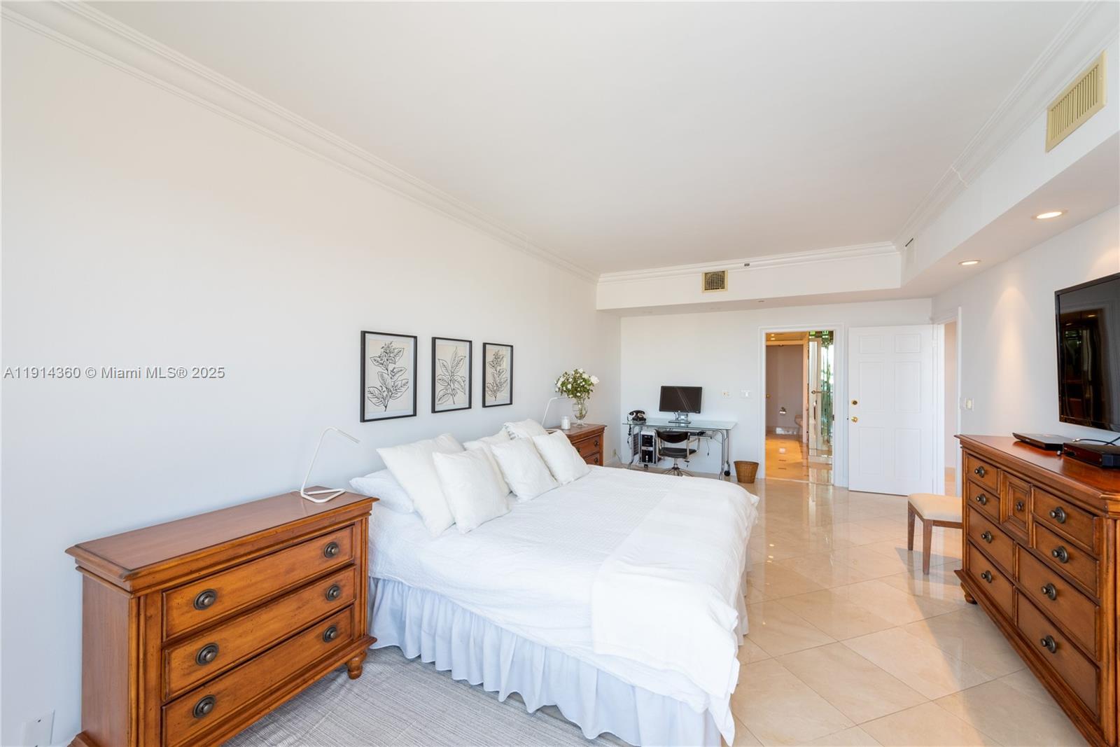 151 Crandon Boulevard, Unit 1036 Key Biscayne, FL 33149 - Photo 13 of 28 a bedroom with furniture and flat screen tv