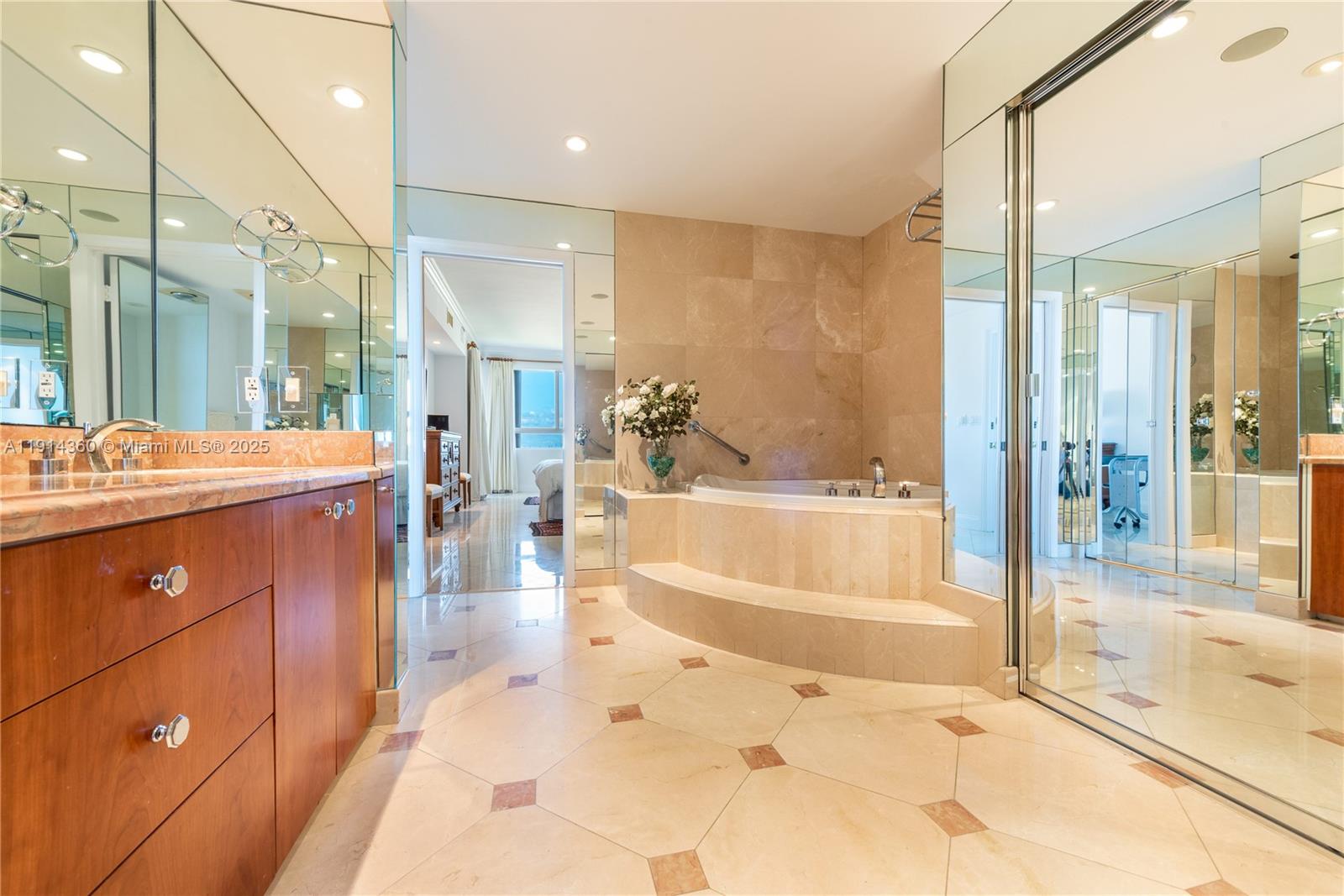 151 Crandon Boulevard, Unit 1036 Key Biscayne, FL 33149 - Photo 14 of 28 a spacious bathroom with a tub sink shower and mirror