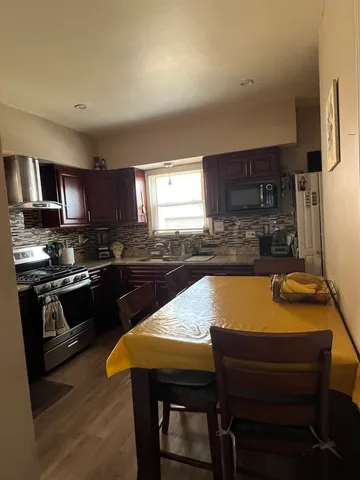 a kitchen with a stove a sink and a refrigerator