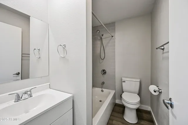 a bathroom with a toilet sink shower and mirror