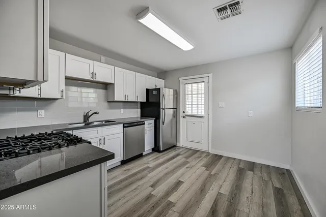 a kitchen with a stove a sink and a refrigerator