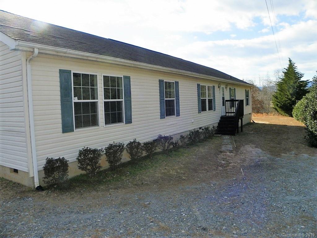 2001 Silver Creek Road Mill Spring, NC 28756 - Photo 1 of 31 a front view of a house with garden