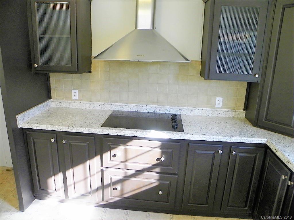2001 Silver Creek Road Mill Spring, NC 28756 - Photo 16 of 31 a kitchen with a sink a stove and cabinets