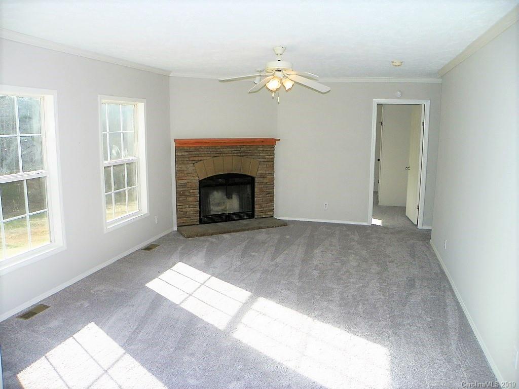 2001 Silver Creek Road Mill Spring, NC 28756 - Photo 17 of 31 a view of an empty room with window and fire place