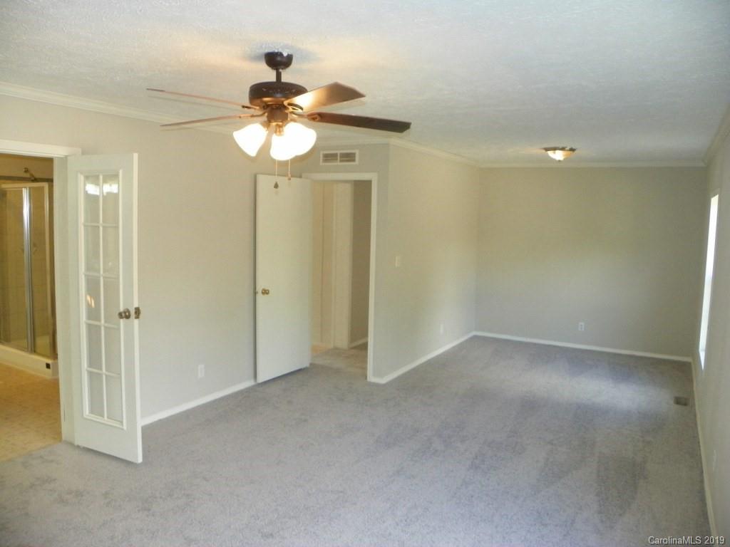 2001 Silver Creek Road Mill Spring, NC 28756 - Photo 20 of 31 a view of an empty room and chandelier fan