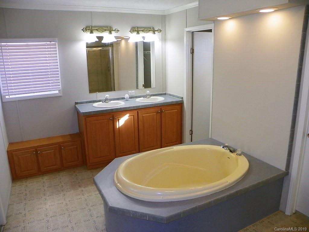 2001 Silver Creek Road Mill Spring, NC 28756 - Photo 21 of 31 a bathroom with a bathtub and a sink