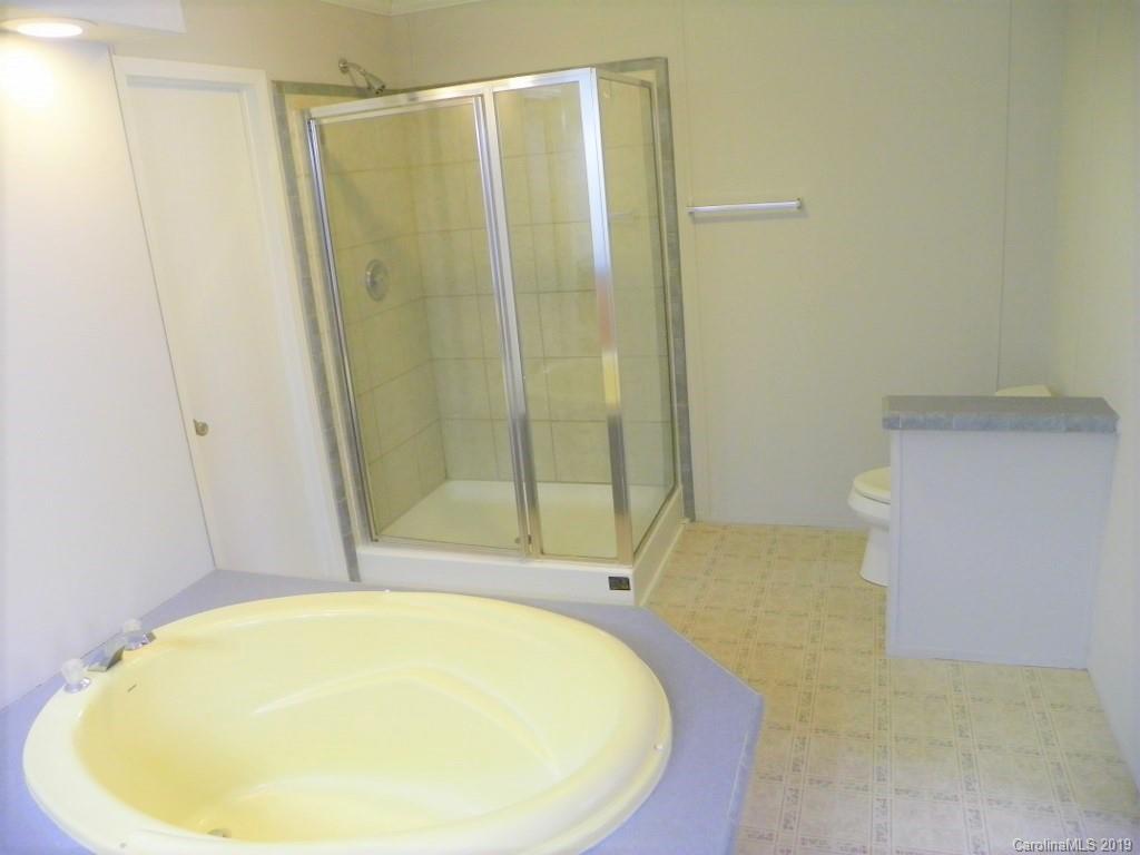 2001 Silver Creek Road Mill Spring, NC 28756 - Photo 22 of 31 a bathroom with a tub and shower