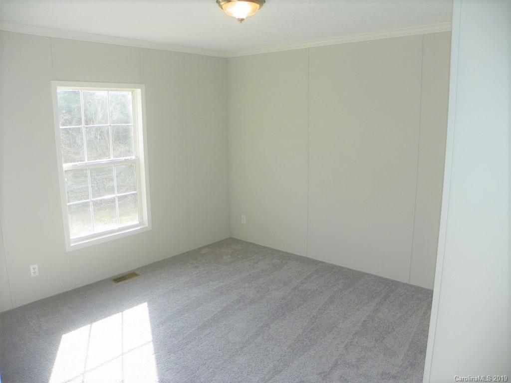 2001 Silver Creek Road Mill Spring, NC 28756 - Photo 24 of 31 an empty room with a window