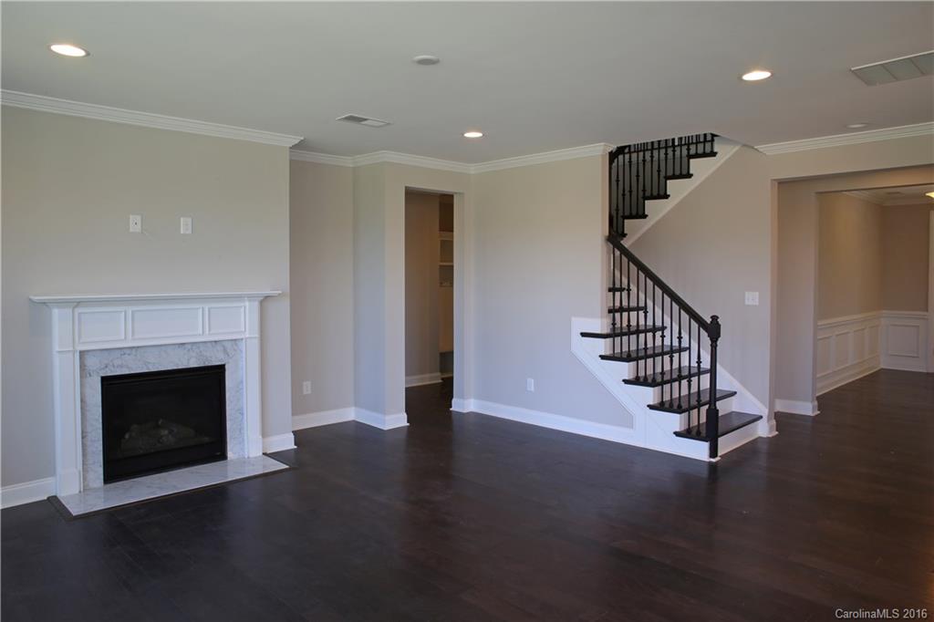 288 Helton Lane, Unit 9 Fort Mill, SC 29708 - Photo 13 of 24 a view of an empty room with wooden floor fireplace and a window