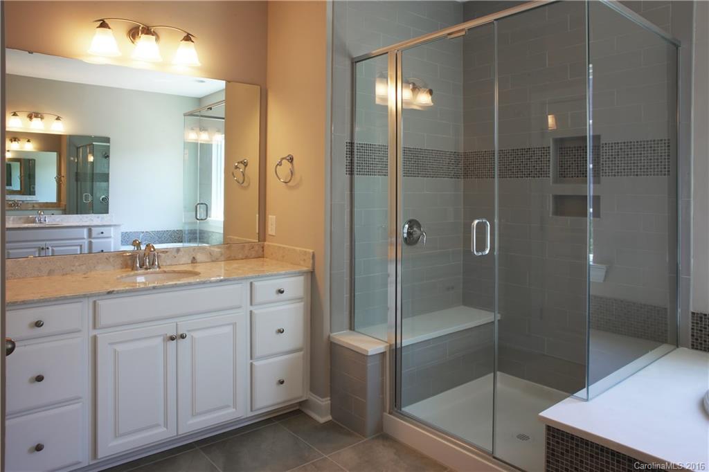 288 Helton Lane, Unit 9 Fort Mill, SC 29708 - Photo 16 of 24 a bathroom with a shower sink and mirror