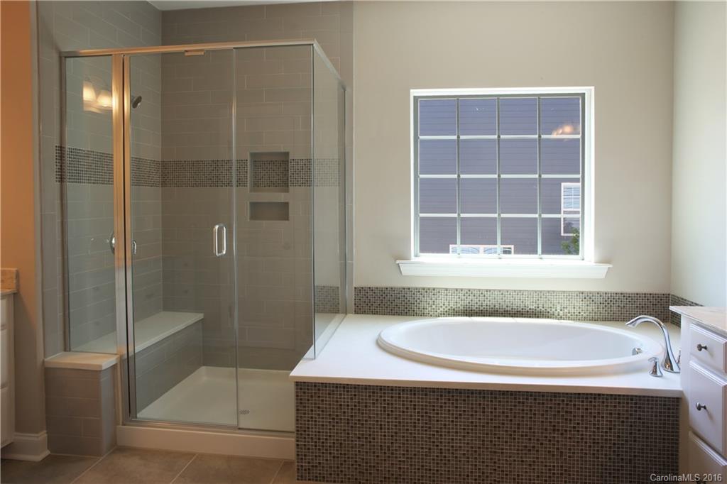 288 Helton Lane, Unit 9 Fort Mill, SC 29708 - Photo 17 of 24 a bathroom with a granite countertop sink a toilet and shower