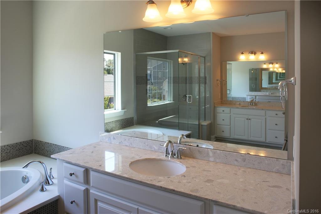 288 Helton Lane, Unit 9 Fort Mill, SC 29708 - Photo 18 of 24 a bathroom with a granite countertop sink and a mirror