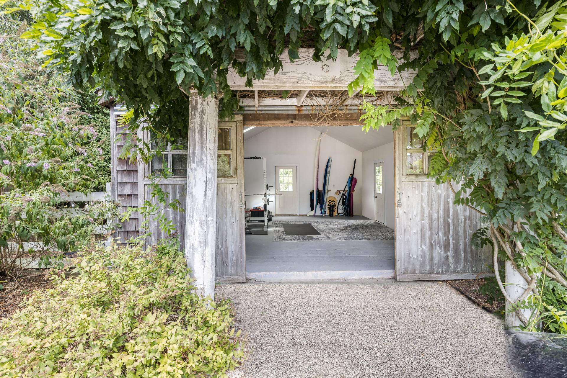 11 Cove Avenue East Sag Harbor, NY 11963 - Photo 14 of 19 a view of a white house with large tree and wooden fence