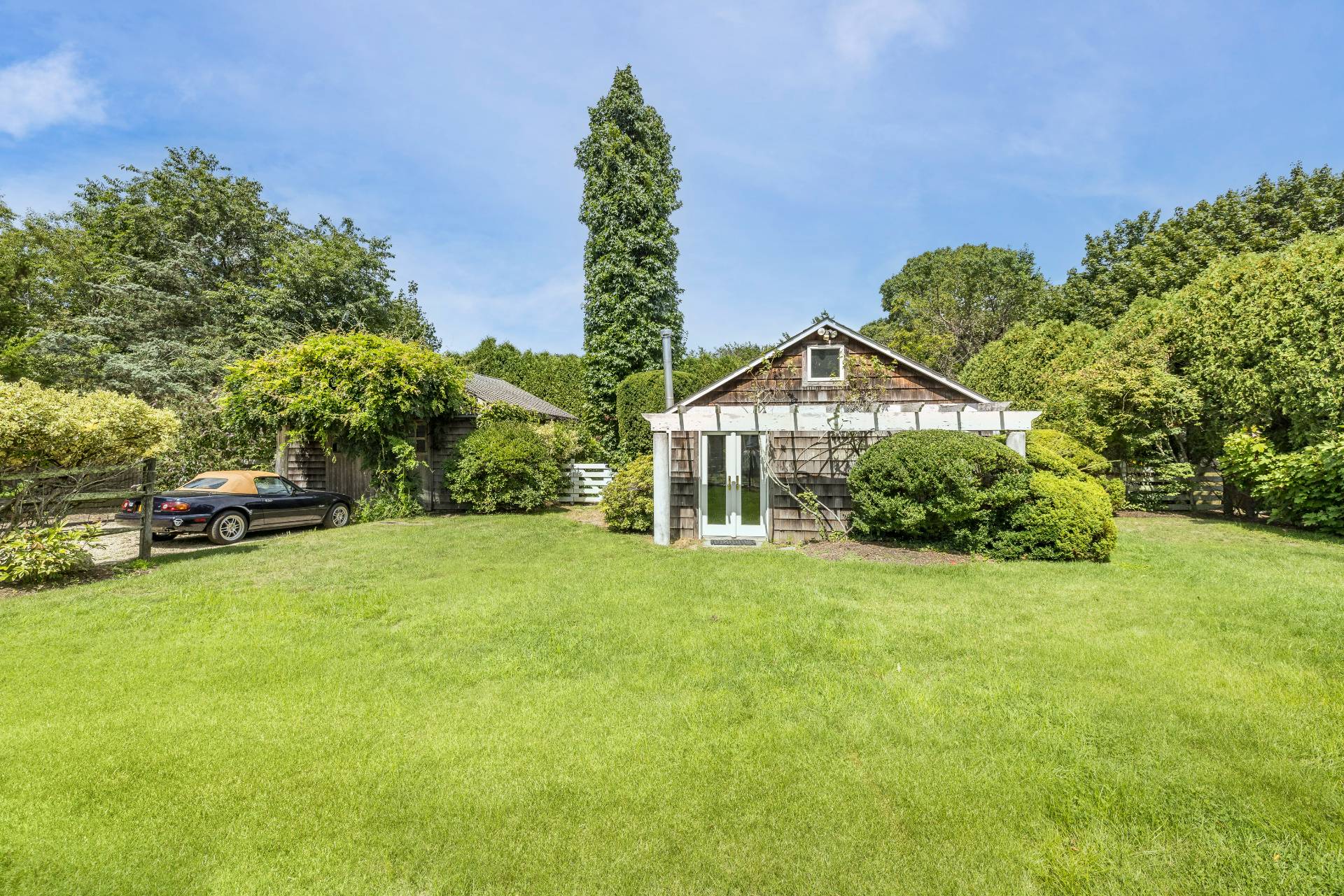 11 Cove Avenue East Sag Harbor, NY 11963 - Photo 16 of 19 a view of a big house with a big yard and large trees