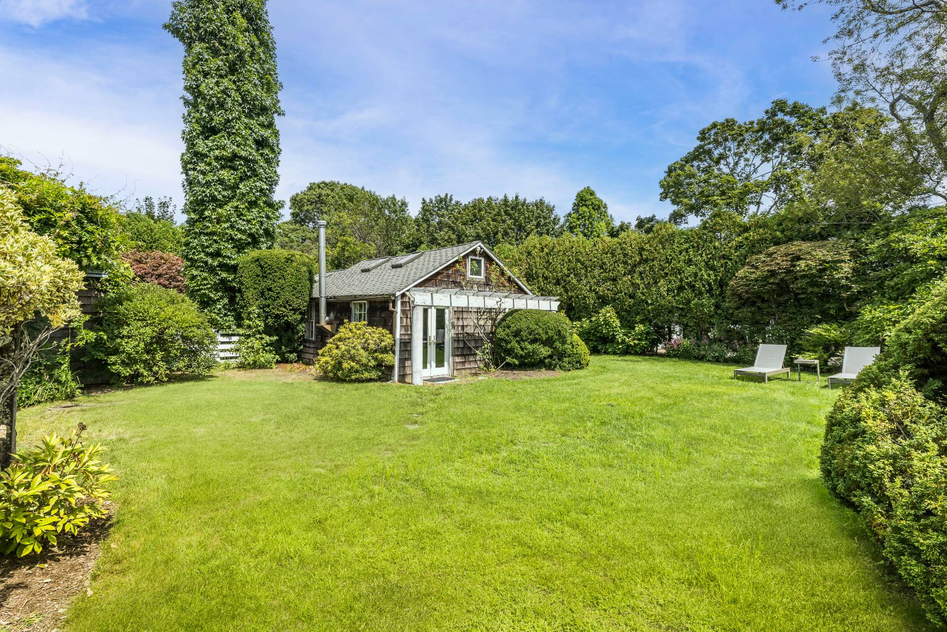 11 Cove Avenue East Sag Harbor, NY 11963 - Photo 17 of 19 a front view of a house with garden