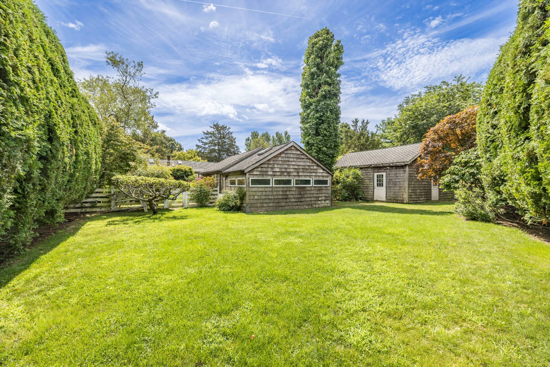 11 Cove Avenue East Sag Harbor, NY 11963 - Photo 18 of 19 a yellow house with swimming pool in front of it