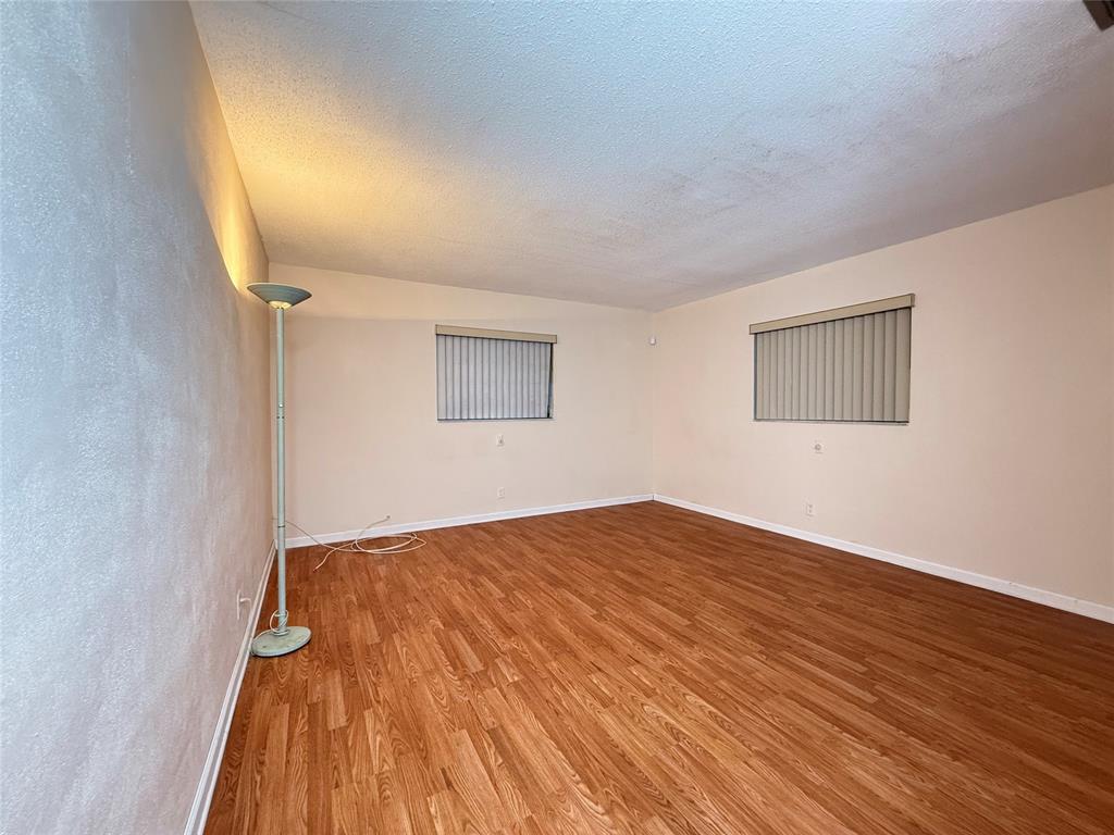 7508 Northwest 67th Avenue Tamarac, FL 33321 - Photo 11 of 17 a view of empty room with wooden floor and fan