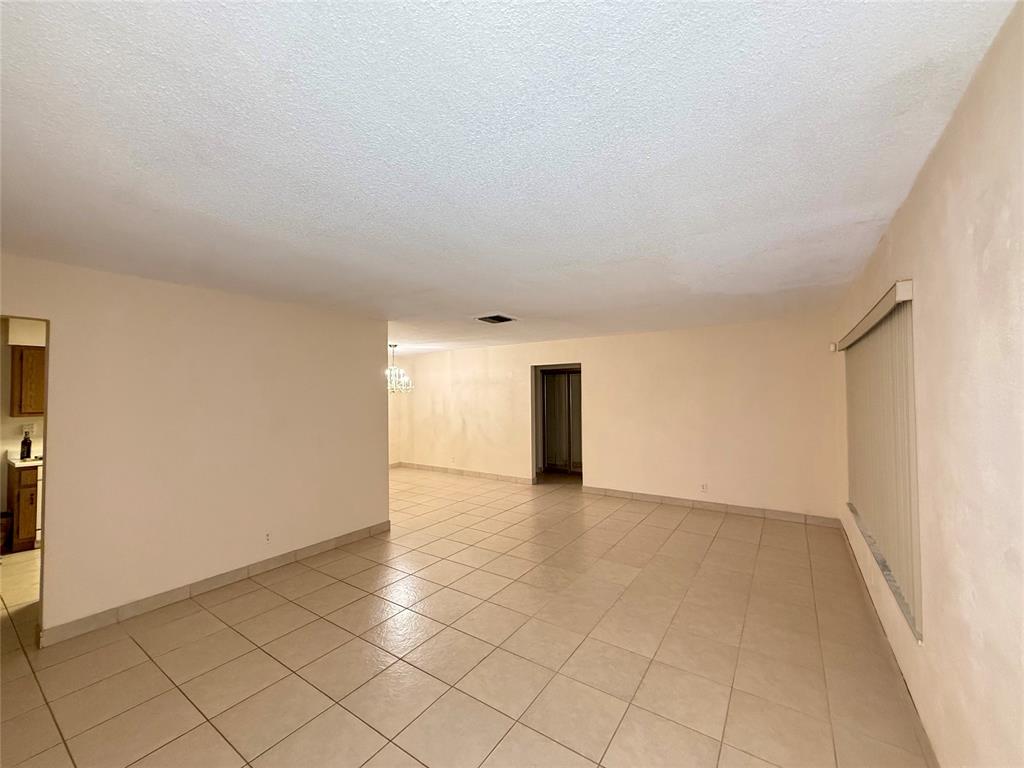 7508 Northwest 67th Avenue Tamarac, FL 33321 - Photo 4 of 17 a view of an empty room and window