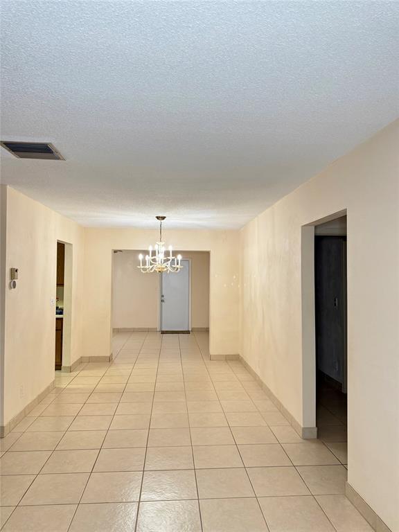 7508 Northwest 67th Avenue Tamarac, FL 33321 - Photo 8 of 17 a view of an empty room with chandelier and a window