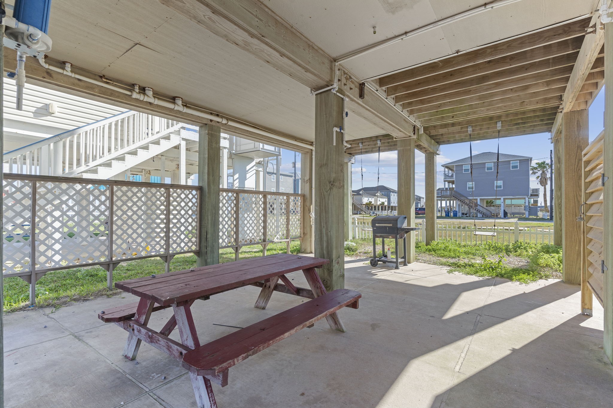 111 Howard Avenue Surfside Beach, TX 77541 - Photo 11 of 33 a backyard of a house with a garden and outdoor seating