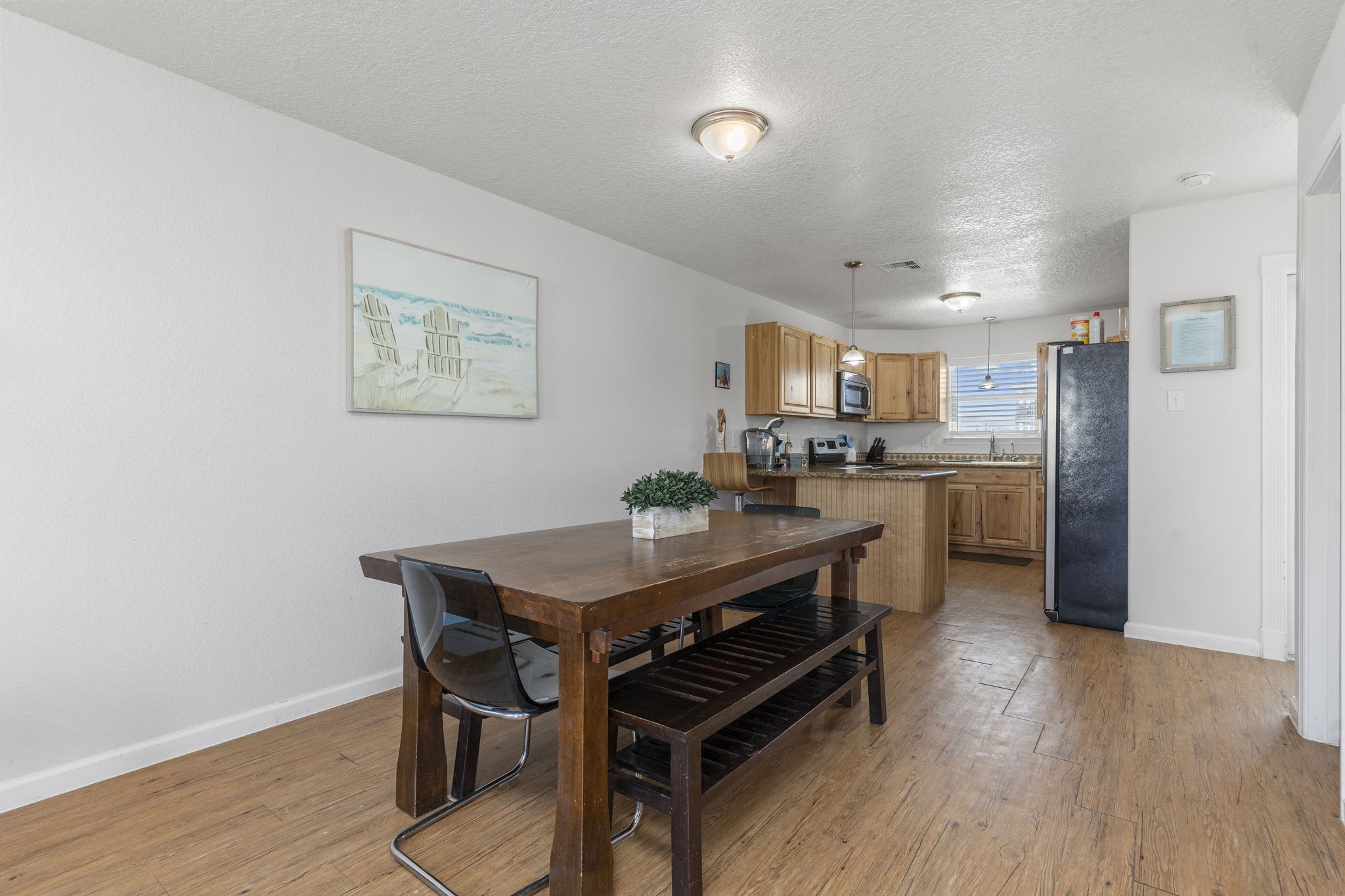 111 Howard Avenue Surfside Beach, TX 77541 - Photo 20 of 33 a view of a dining room with furniture and wooden floor