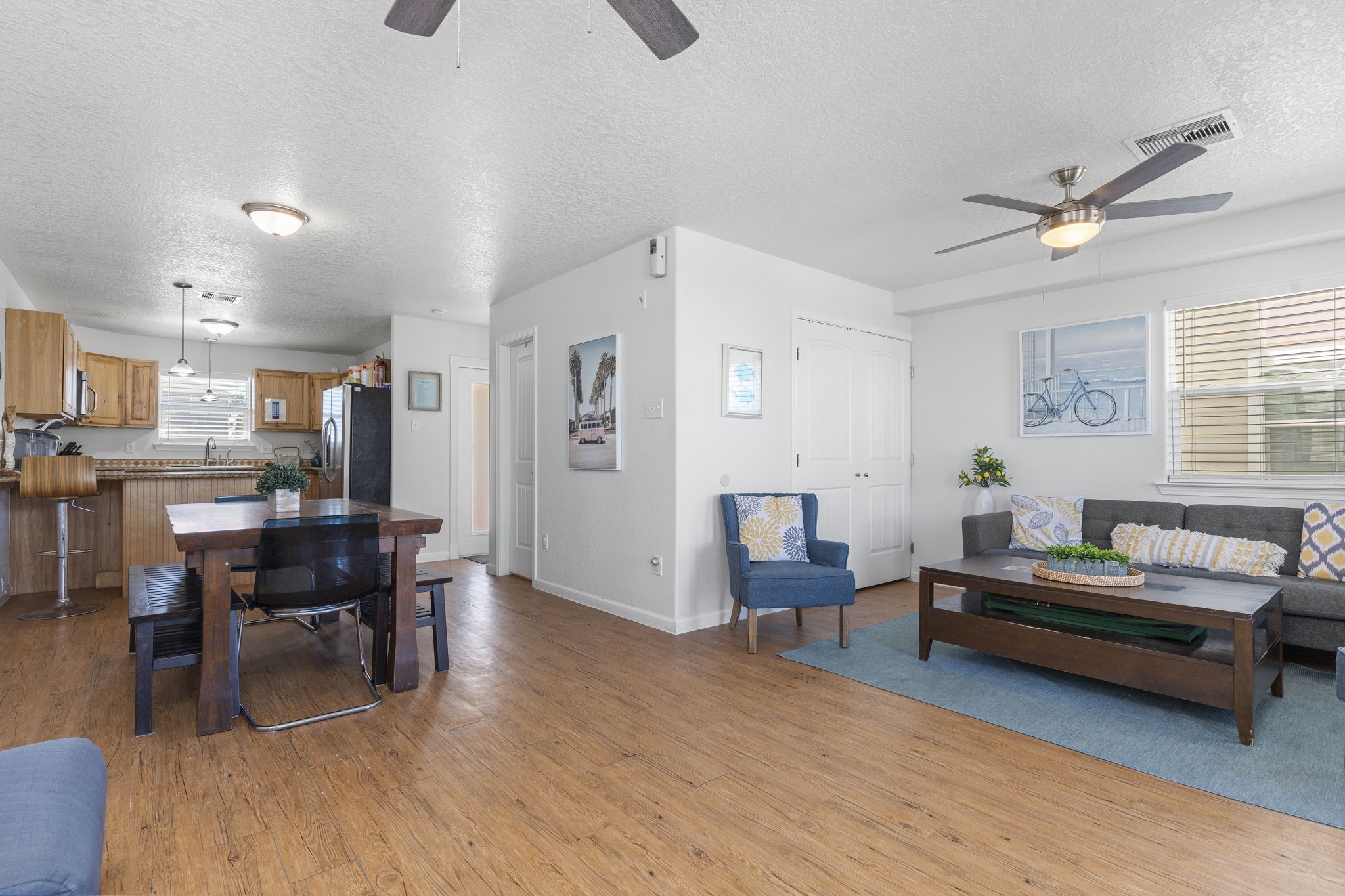 111 Howard Avenue Surfside Beach, TX 77541 - Photo 21 of 33 a living room with furniture and a dining table with wooden floor