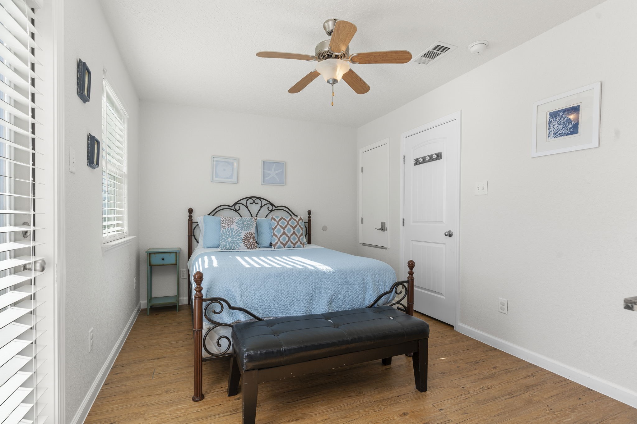 111 Howard Avenue Surfside Beach, TX 77541 - Photo 29 of 33 a bedroom with a bed and a chandelier