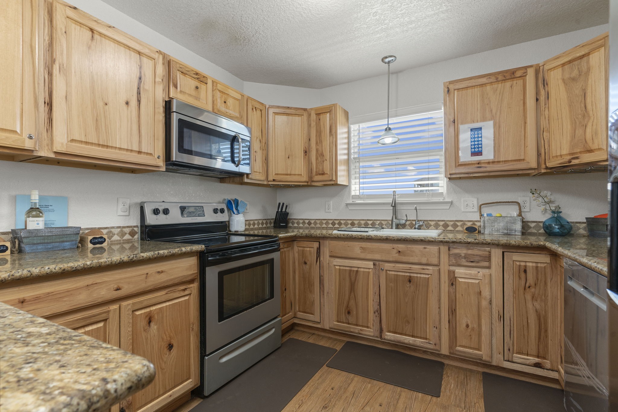 111 Howard Avenue Surfside Beach, TX 77541 - Photo 3 of 33 a kitchen with stainless steel appliances granite countertop a sink and cabinets