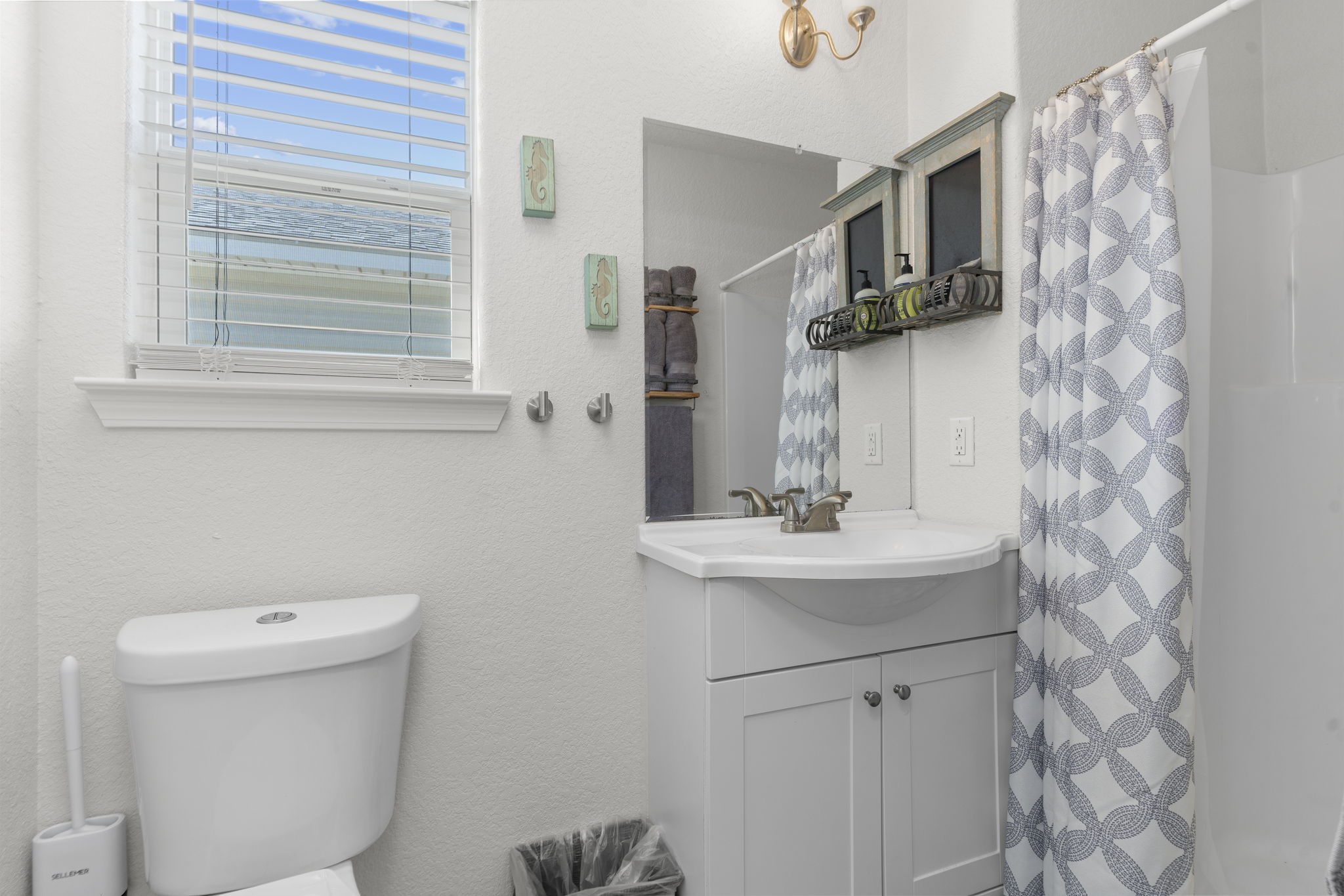 111 Howard Avenue Surfside Beach, TX 77541 - Photo 32 of 33 a bathroom with a sink a toilet and mirror
