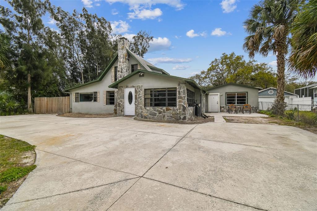 a front view of a house with a garden and yard