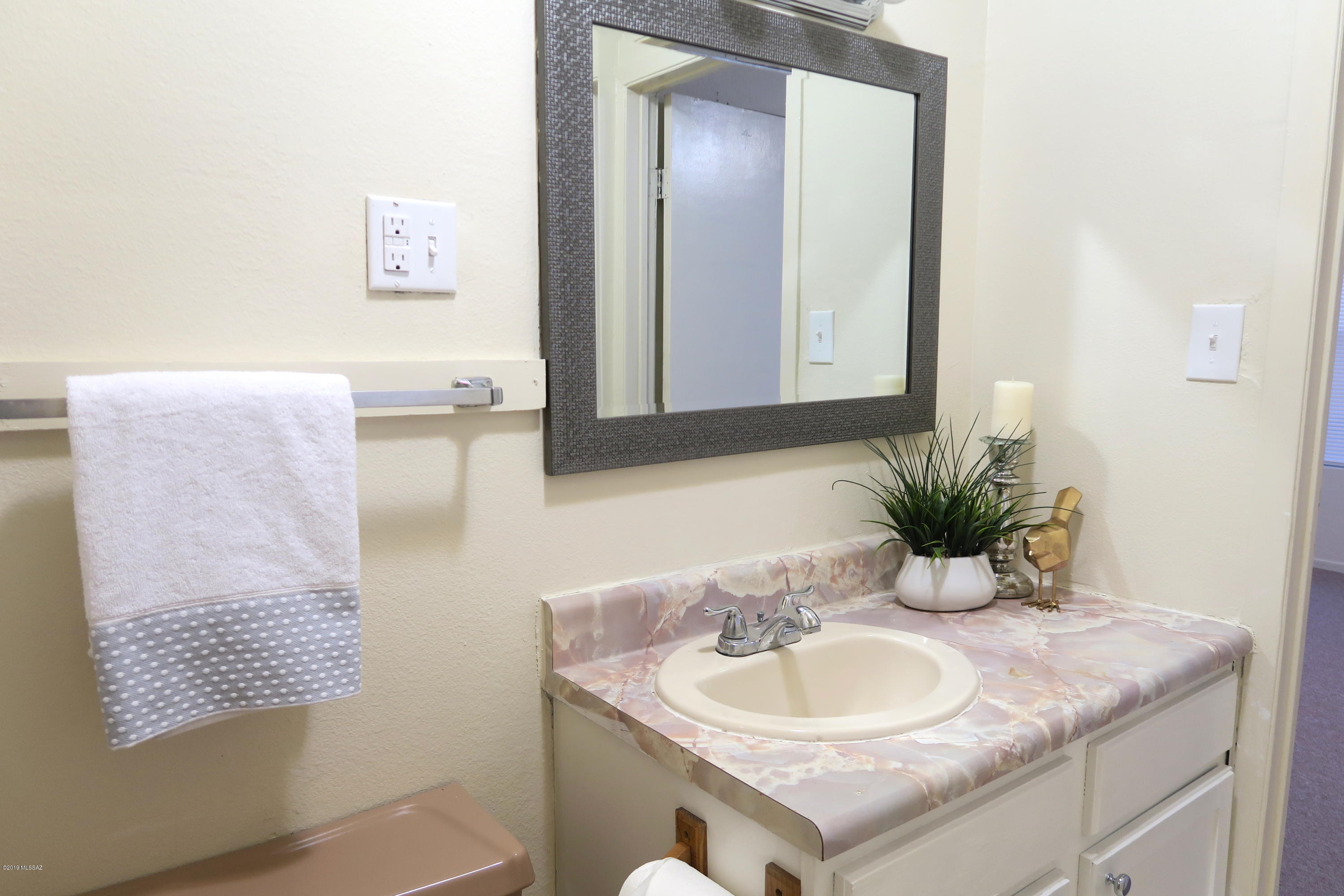410 Sykes Circle Rio Rico, AZ 85648 - Photo 9 of 13 a bathroom with a granite countertop sink and a mirror