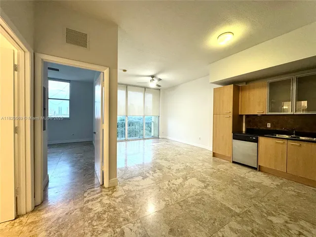 a view of a kitchen with a sink and cabinets