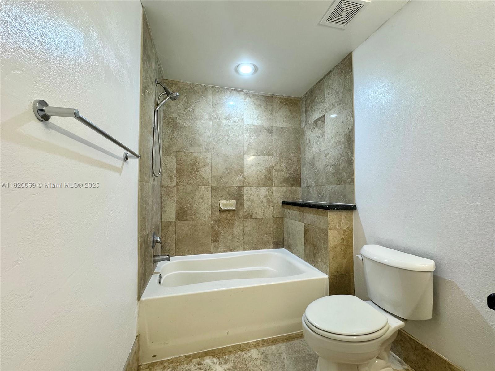 1350 Northwest 8th Court, Unit B35 Miami, FL 33136 - Photo 13 of 22 a bathroom with a toilet and a bath tub