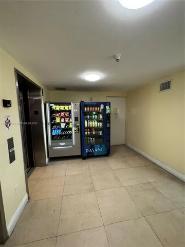 a view of an empty room with window and fireplace