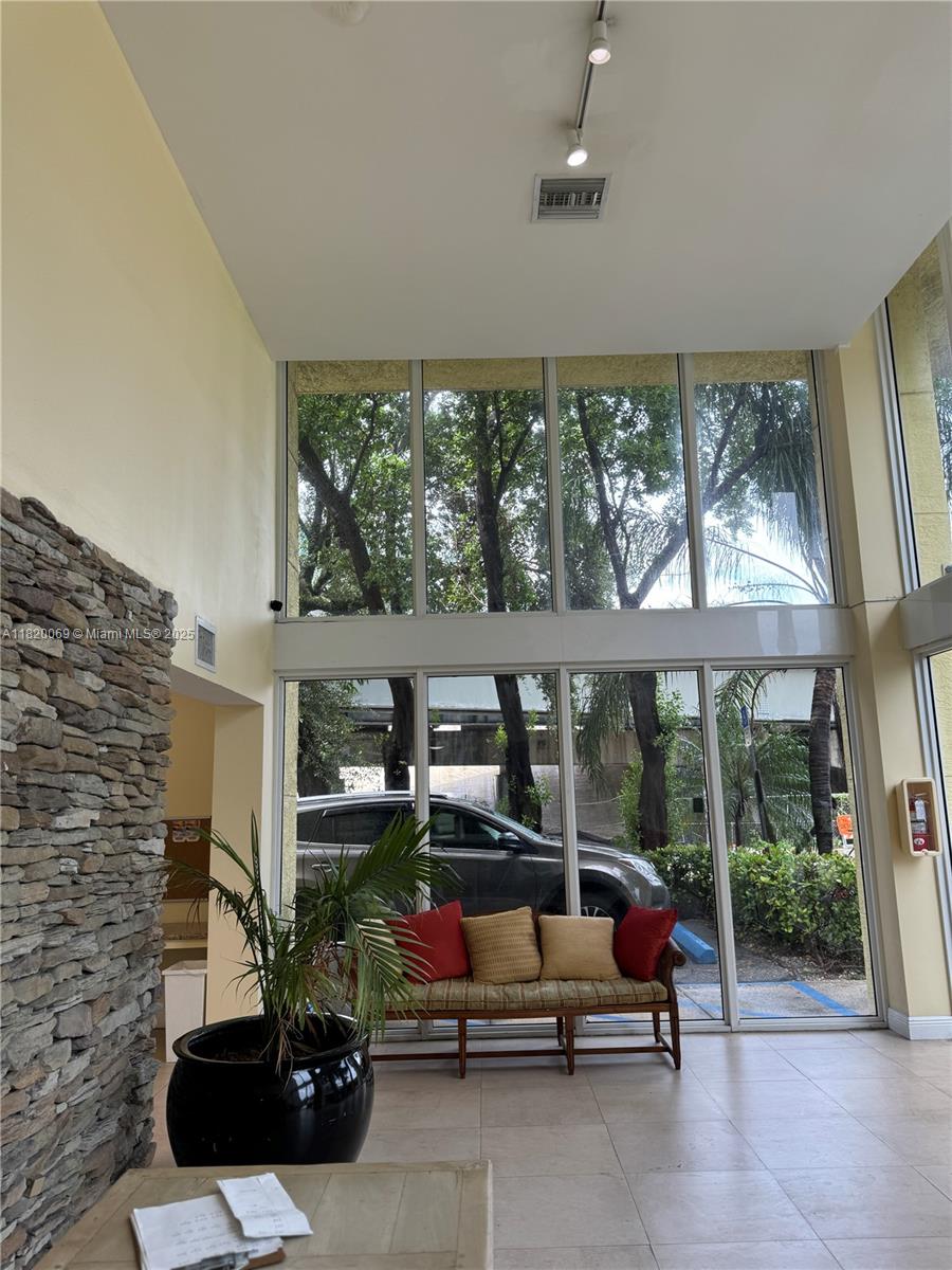 1350 Northwest 8th Court, Unit B35 Miami, FL 33136 - Photo 21 of 22 a living room with furniture and a floor to ceiling window